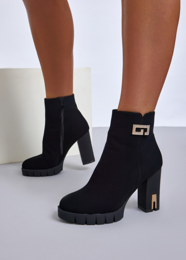 Black high heel ankle boots with gold accent